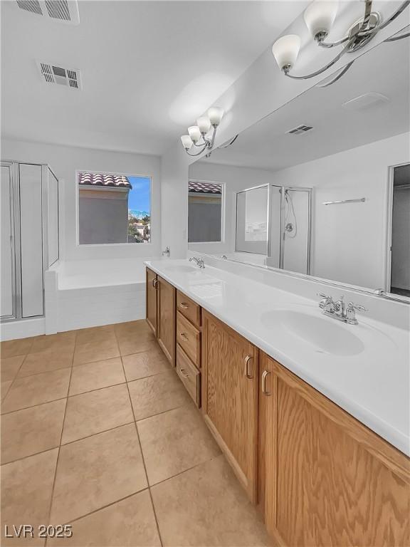 bathroom with tile patterned floors, vanity, and separate shower and tub