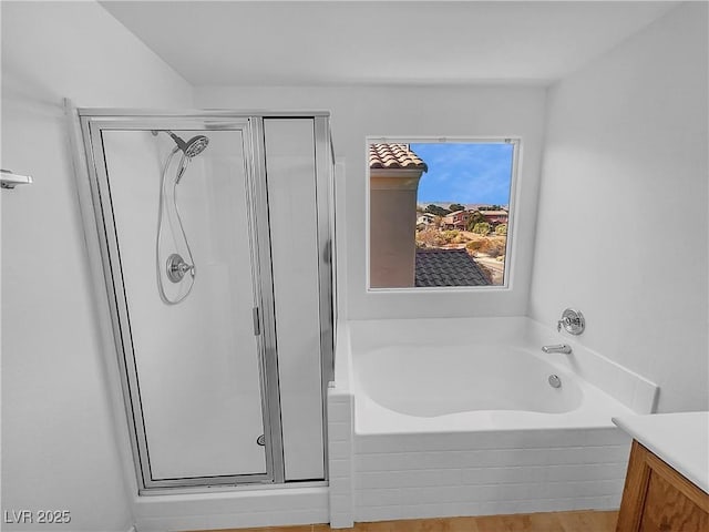 bathroom featuring independent shower and bath, hardwood / wood-style floors, and vanity