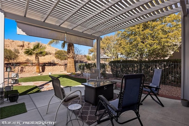 view of patio / terrace with a fire pit and a pergola