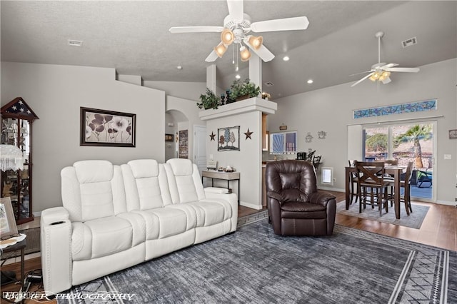 living room with vaulted ceiling, dark wood-type flooring, and ceiling fan