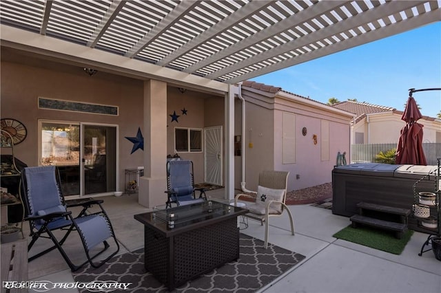 view of patio / terrace featuring an outdoor fire pit, a hot tub, and a pergola