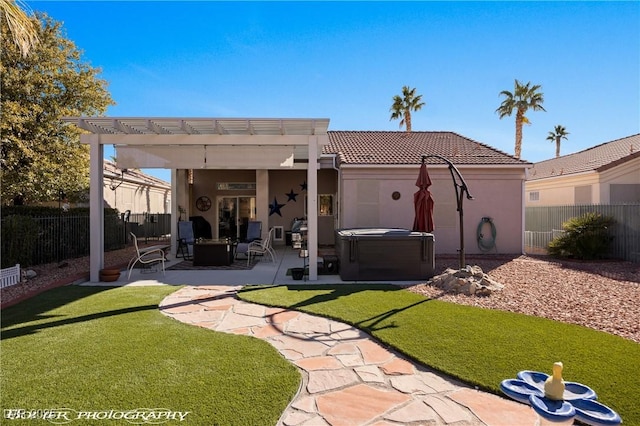 rear view of property with a hot tub, a patio, a yard, and a pergola