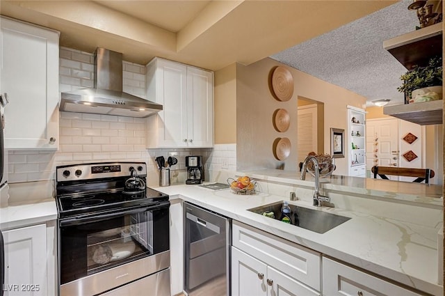 kitchen featuring white cabinets, appliances with stainless steel finishes, wall chimney exhaust hood, sink, and backsplash