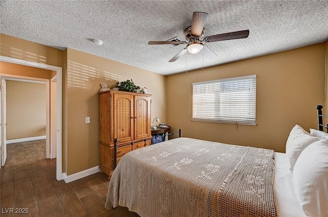 bedroom featuring ceiling fan, dark wood-type flooring, and a textured ceiling