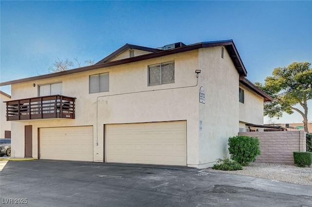 exterior space with a balcony and a garage