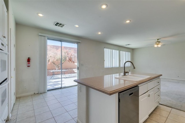 kitchen with a kitchen island with sink, dishwasher, sink, and white cabinetry