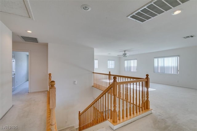 hallway featuring light carpet