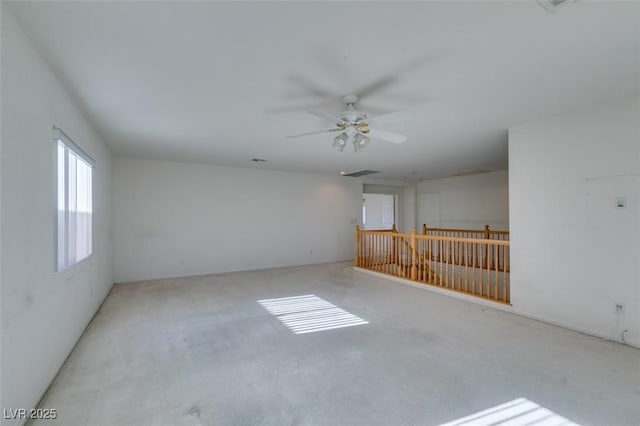 carpeted empty room featuring ceiling fan