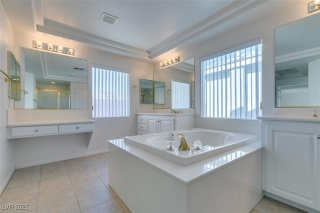 bathroom featuring plus walk in shower, vanity, a raised ceiling, and tile patterned flooring