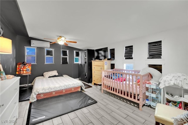 bedroom with a wall unit AC, ceiling fan, and vaulted ceiling