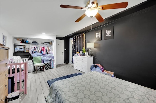 bedroom with ceiling fan and light hardwood / wood-style floors