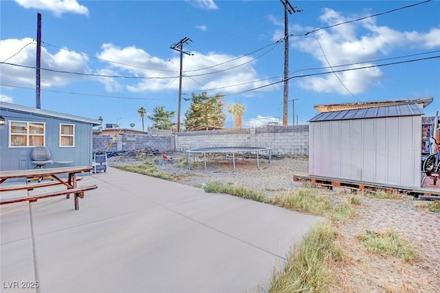 view of patio / terrace featuring a shed and a trampoline