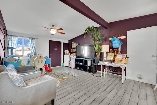 living room with beam ceiling and ceiling fan