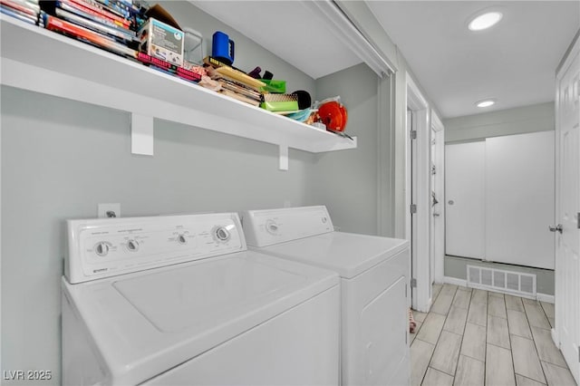 clothes washing area with washer and dryer