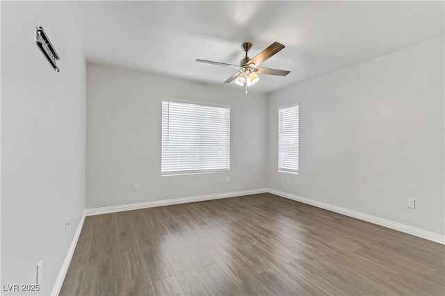 spare room featuring ceiling fan and dark hardwood / wood-style flooring