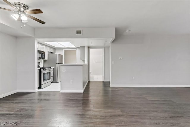 unfurnished living room featuring ceiling fan and hardwood / wood-style flooring