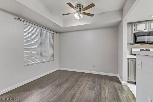 interior space with ceiling fan and dark hardwood / wood-style floors