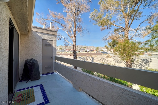 view of patio / terrace featuring a grill and a balcony