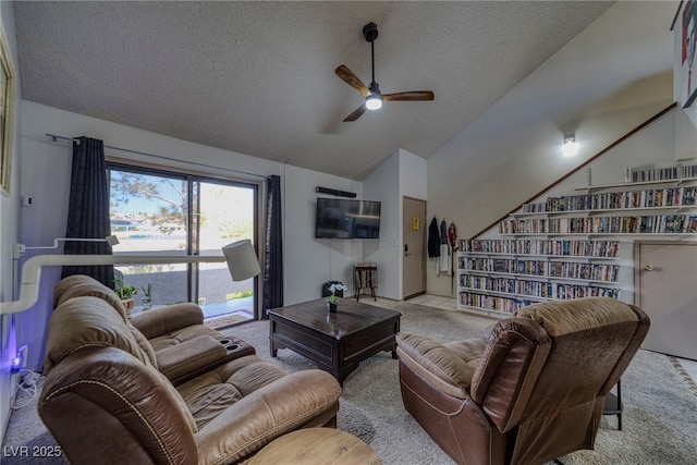 carpeted living room featuring a textured ceiling, ceiling fan, and lofted ceiling