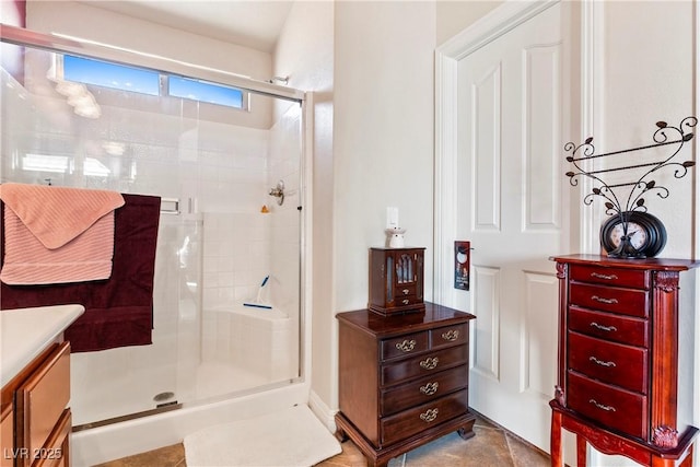 bathroom with vanity, an enclosed shower, and tile patterned flooring