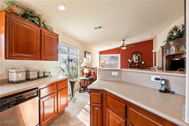 kitchen featuring stainless steel dishwasher, vaulted ceiling, light tile patterned floors, and ceiling fan