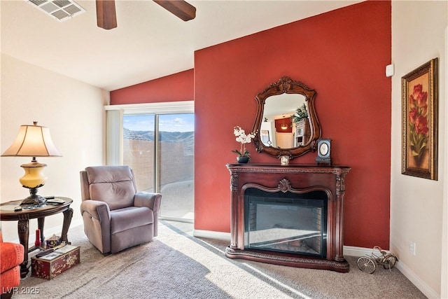 sitting room with ceiling fan, carpet floors, and lofted ceiling