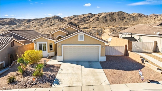 view of front of property with a mountain view and a garage