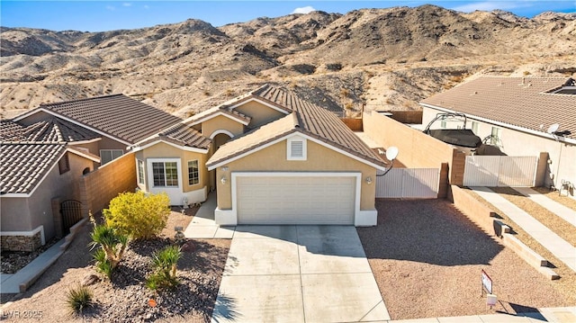 view of front of property with a mountain view and a garage