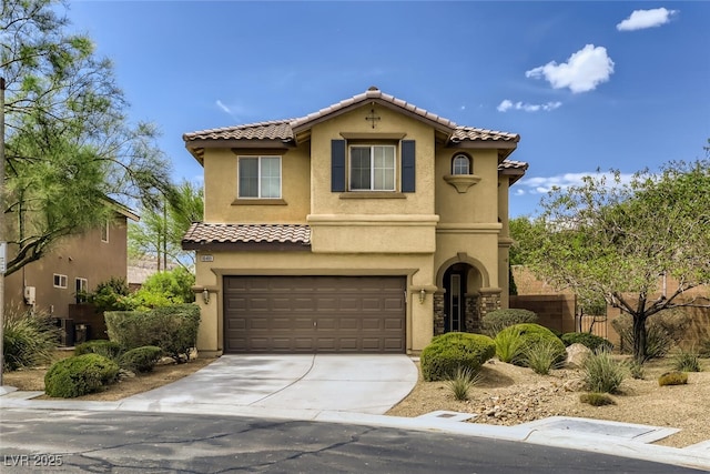 mediterranean / spanish-style home featuring a garage and central AC