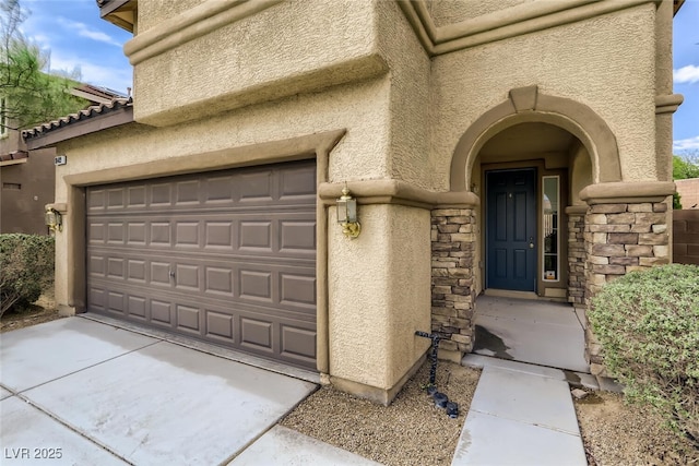 doorway to property with a garage