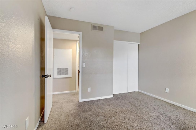 unfurnished bedroom featuring carpet floors and a closet