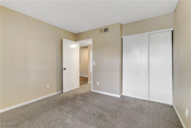 unfurnished bedroom featuring a closet and carpet flooring