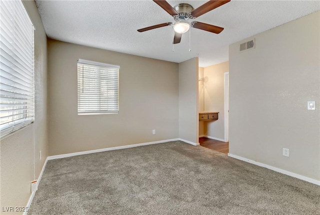 unfurnished bedroom featuring ceiling fan, a textured ceiling, and carpet floors