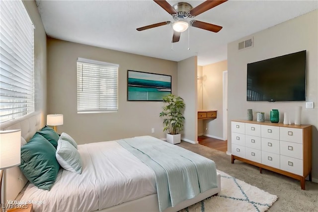 bedroom featuring ceiling fan and light colored carpet