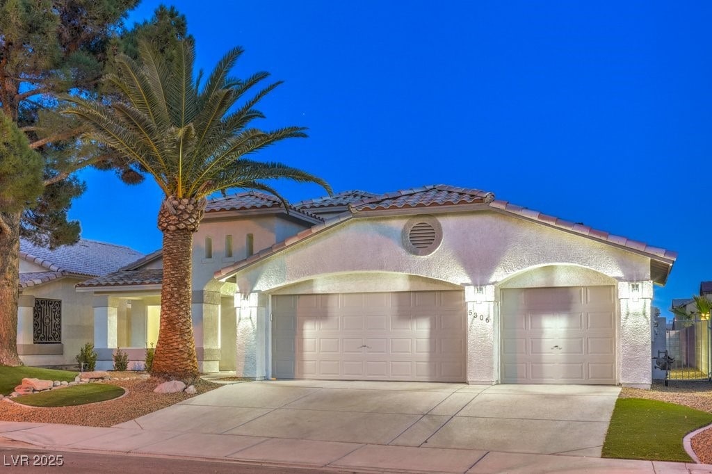 mediterranean / spanish home with a garage