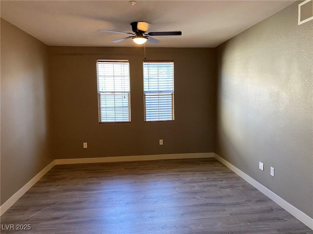 empty room with ceiling fan and hardwood / wood-style floors