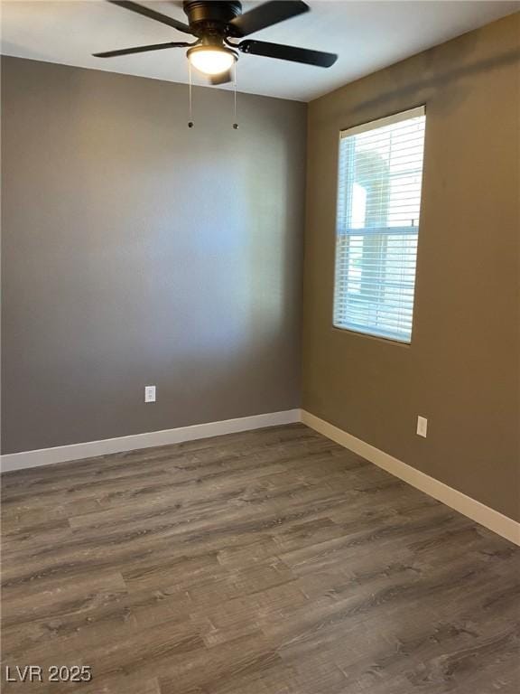 unfurnished room featuring ceiling fan and dark wood-type flooring