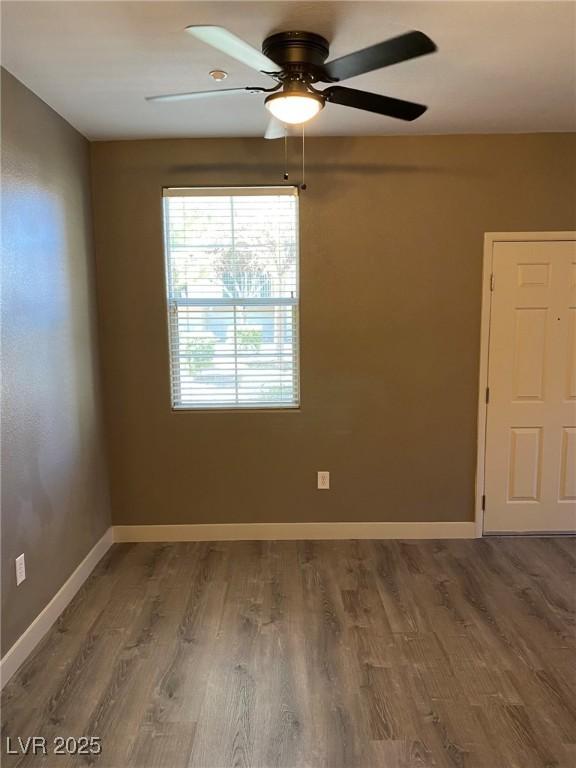 empty room with ceiling fan and wood-type flooring