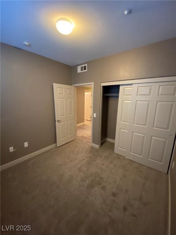 unfurnished bedroom with carpet and a closet