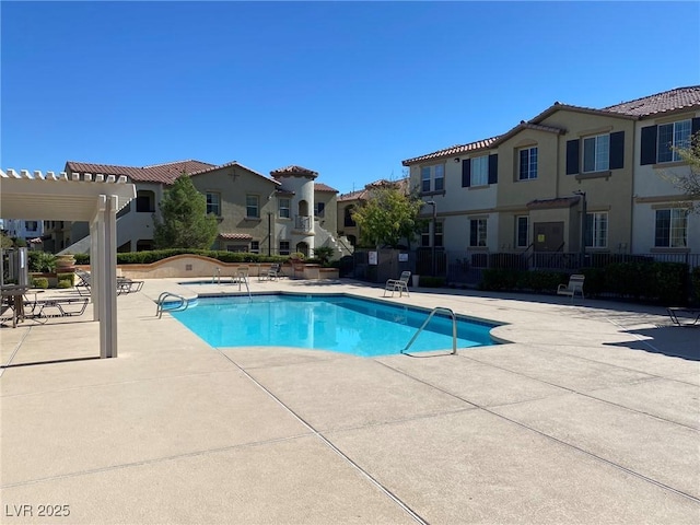 view of pool with a pergola and a patio area