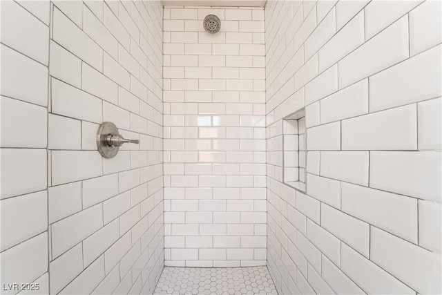 bathroom with tiled shower