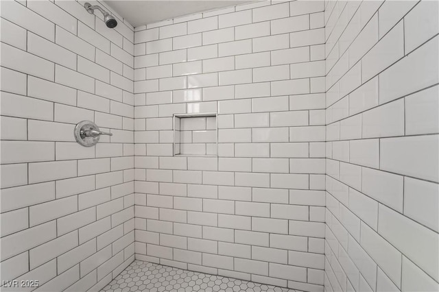 bathroom with tiled shower