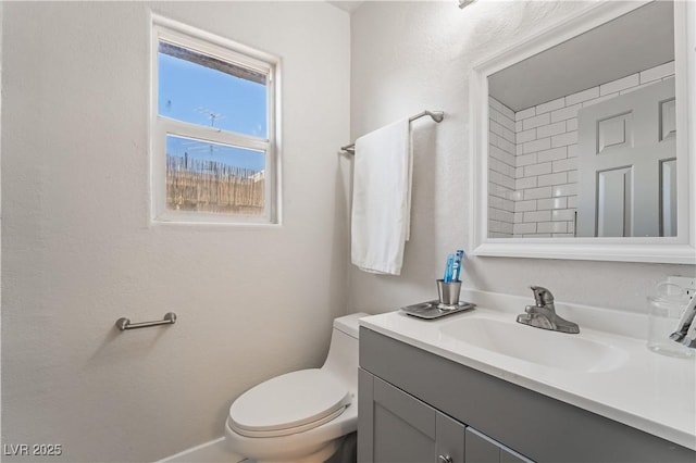 bathroom with toilet and vanity