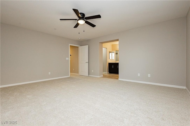 unfurnished bedroom with light colored carpet, ceiling fan, ensuite bath, and baseboards