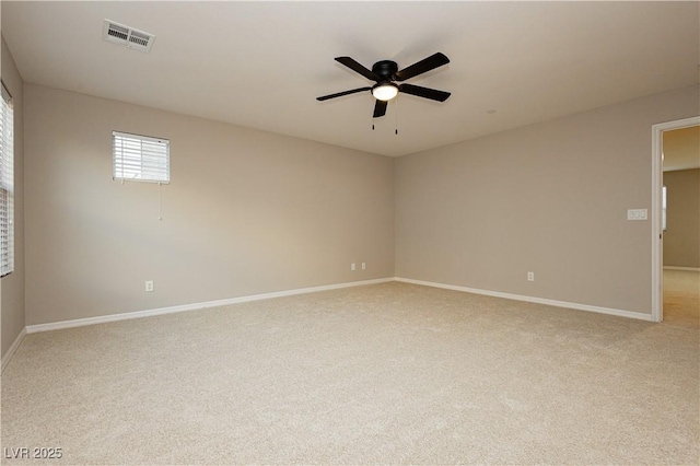 unfurnished room with light carpet, ceiling fan, visible vents, and baseboards