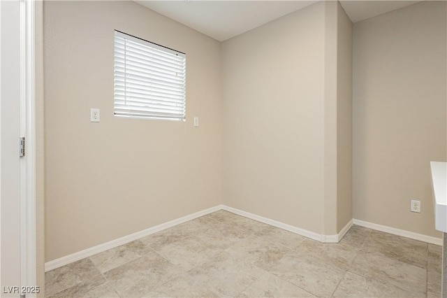 spare room with baseboards