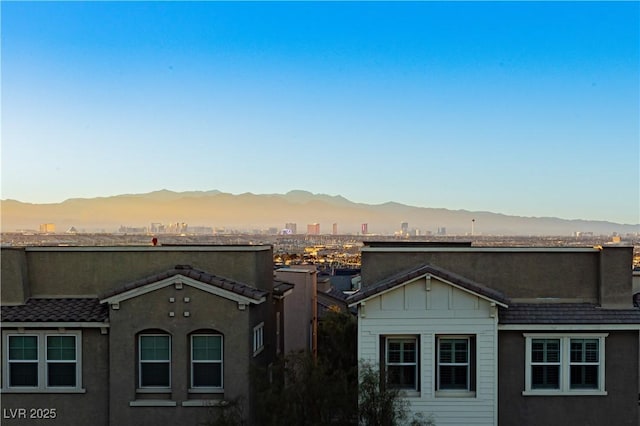 property's view of city featuring a mountain view