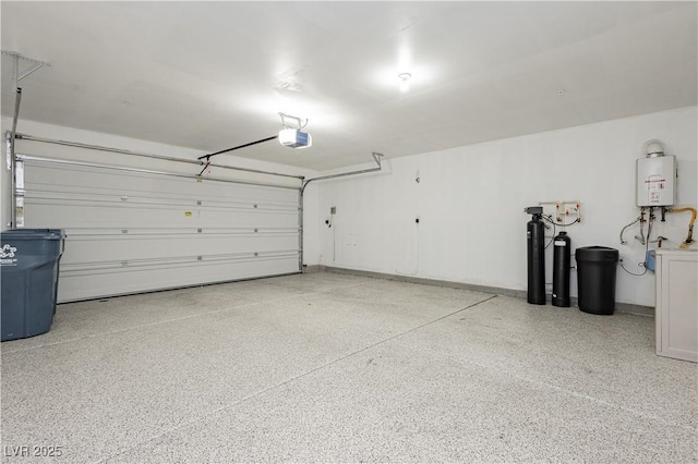 garage featuring a garage door opener and water heater