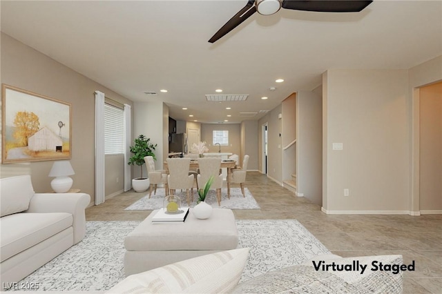 living room featuring a healthy amount of sunlight, ceiling fan, visible vents, and recessed lighting