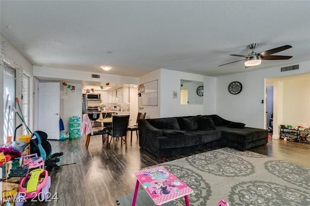 living room featuring hardwood / wood-style flooring and ceiling fan